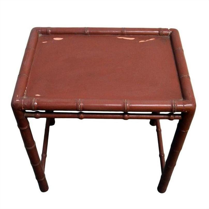 Red bamboo side table with square top and bamboo-style legs on white background.
