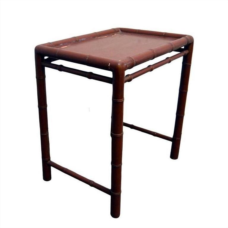 Red bamboo side table with rectangular top and bamboo-inspired legs, accent piece for home decor.