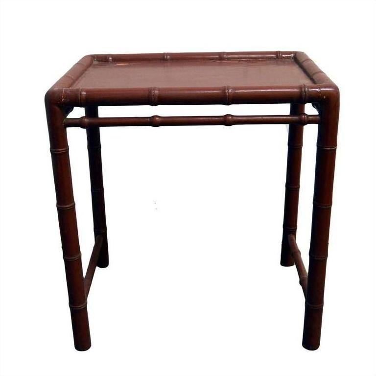 Red bamboo side table with bamboo-style legs and flat top, modern style furniture for interior use.