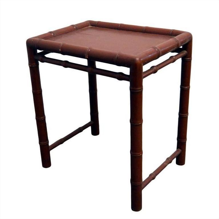 Red bamboo-style side table with reddish-brown finish, featuring bamboo-like legs and edges, close-up view.