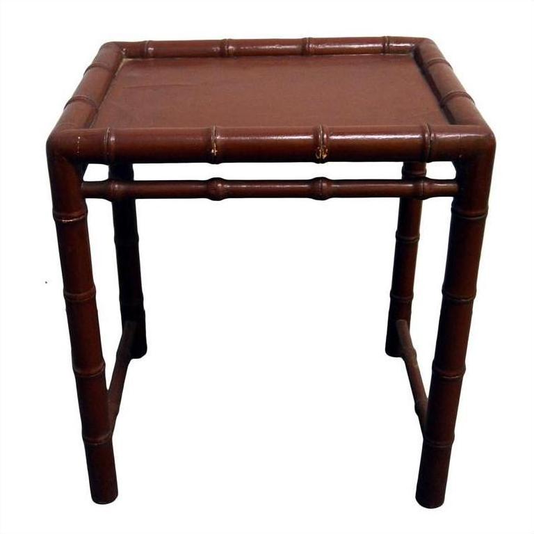 Red bamboo side table with bamboo-inspired legs and edges, shown in close-up against a plain background.