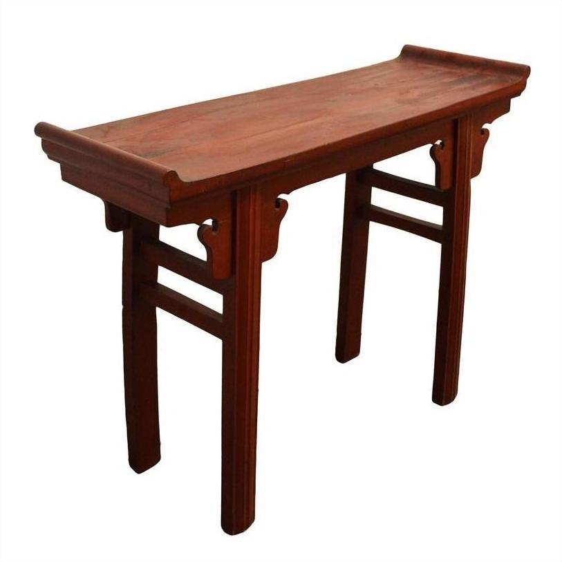Red patina wood altar table with curved edges, decorative supports, and four straight legs.