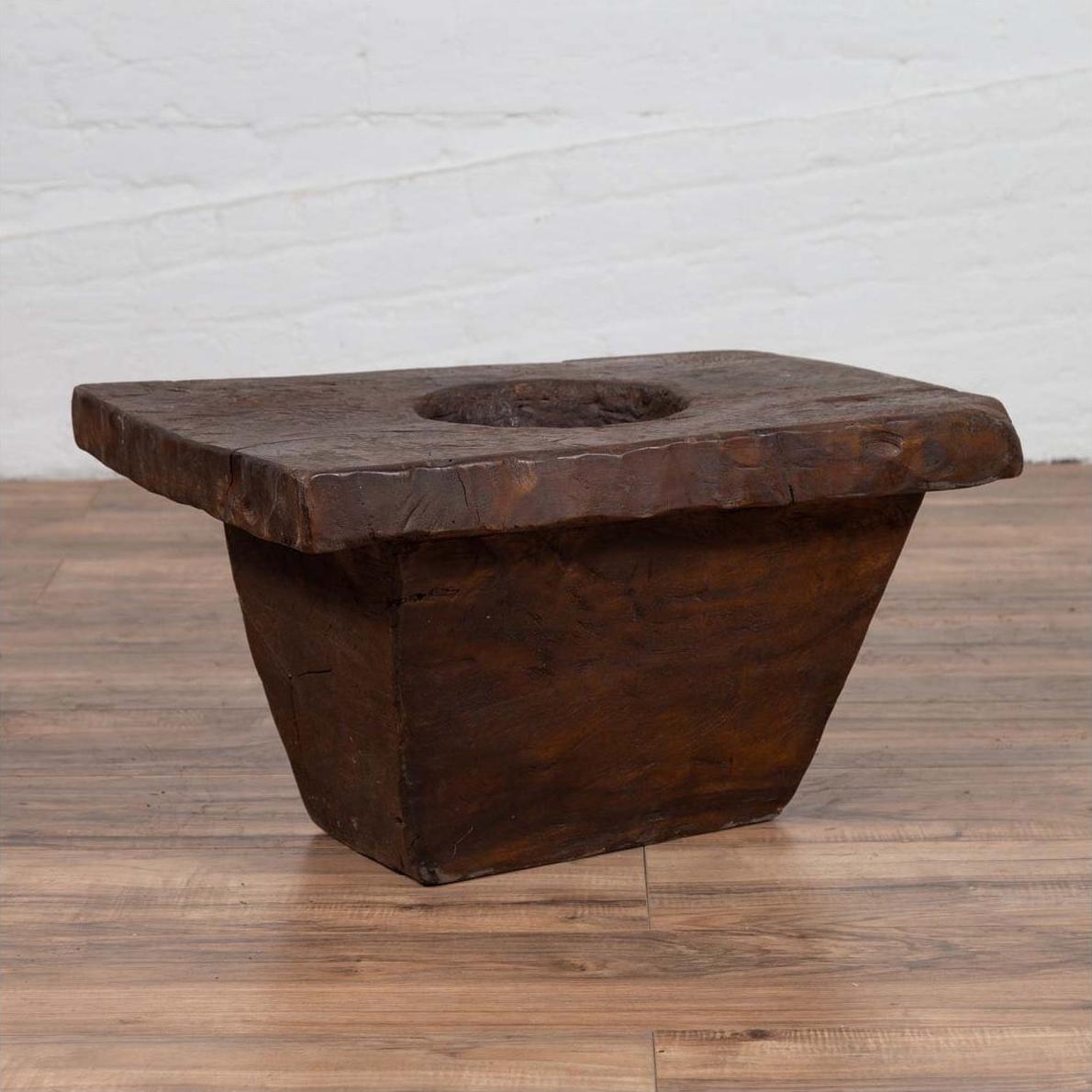Brown wooden planter with square top, round center, and tapered base, early 20th century, rustic style.