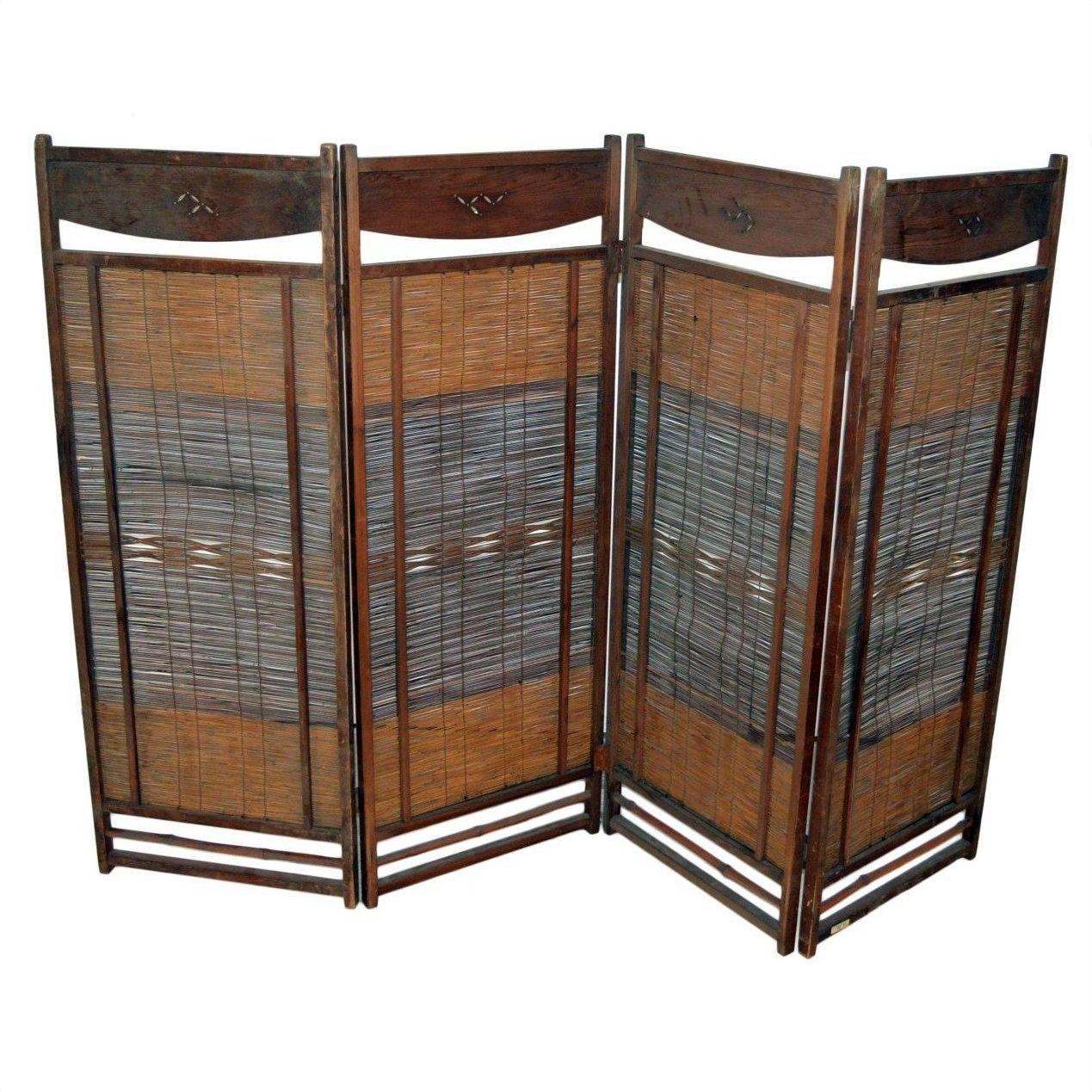 Dark brown frame four-panel room divider with woven rattan panels, indoor setting.