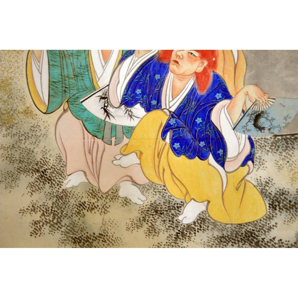 Blue and yellow figure on traditional Japanese artwork next to vintage 2-panel screen with fictional characters.