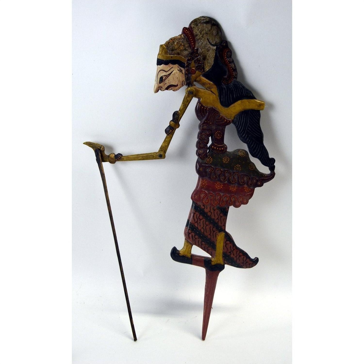 Brown wooden Wayang Kulit shadow puppets with painted details, set of three, on white background.