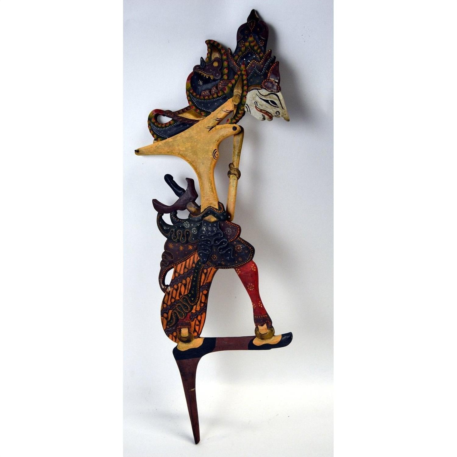 Colorful wooden Wayang Kulit Indonesian shadow puppets with intricate patterns, set of 3, close-up view.