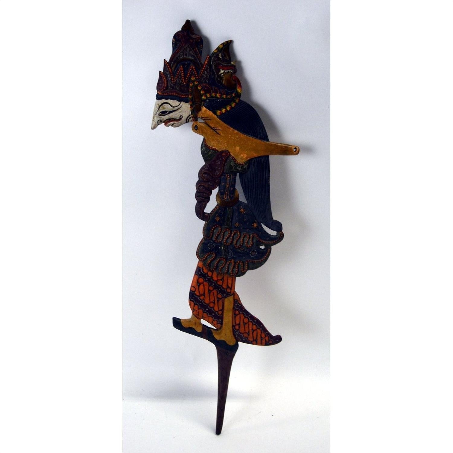 Colorful wooden Wayang Kulit puppets with distinct facial features, set of three, displayed together.