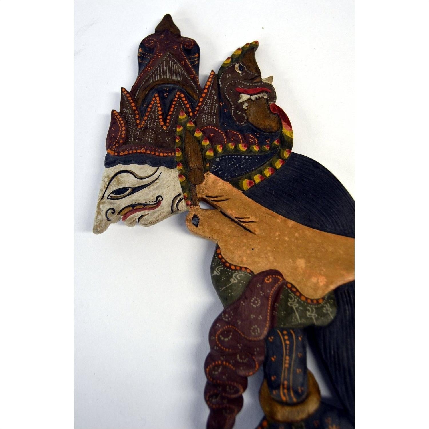 Colorful wooden Wayang Kulit Indonesian shadow puppets with intricate detailing, set of three.