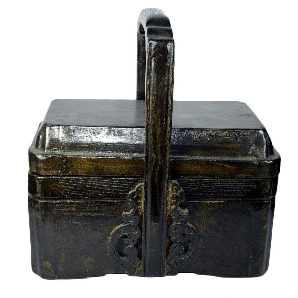 Dark wood elm wedding box with tall curved handle and decorative front, rectangular, close-up view.