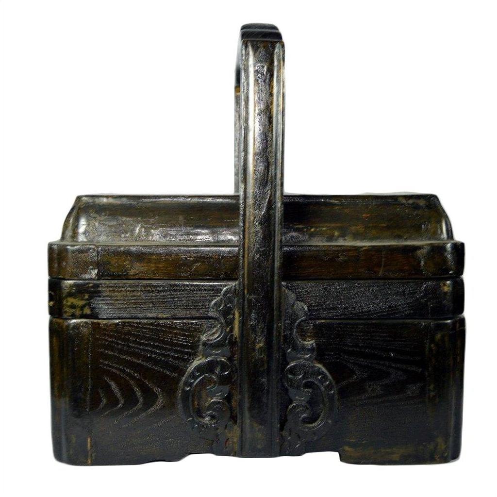 Brown elm wood wedding box with ornate carvings and tall center handle, front view, in good condition.