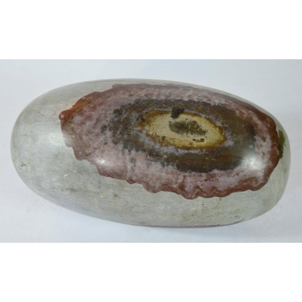 Brown, red, and tan stone Shiva Lingam with smooth oval patterns, close-up view.