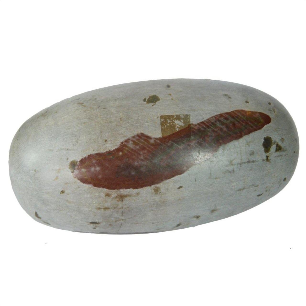 Close-up of an oval gray stone Shiva Lingam with a reddish-brown stripe and worn surface patches.