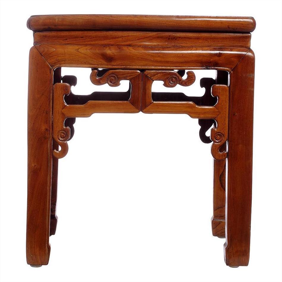 Natural wood side table with decorative carved legs and side detailing, shown on a white background.