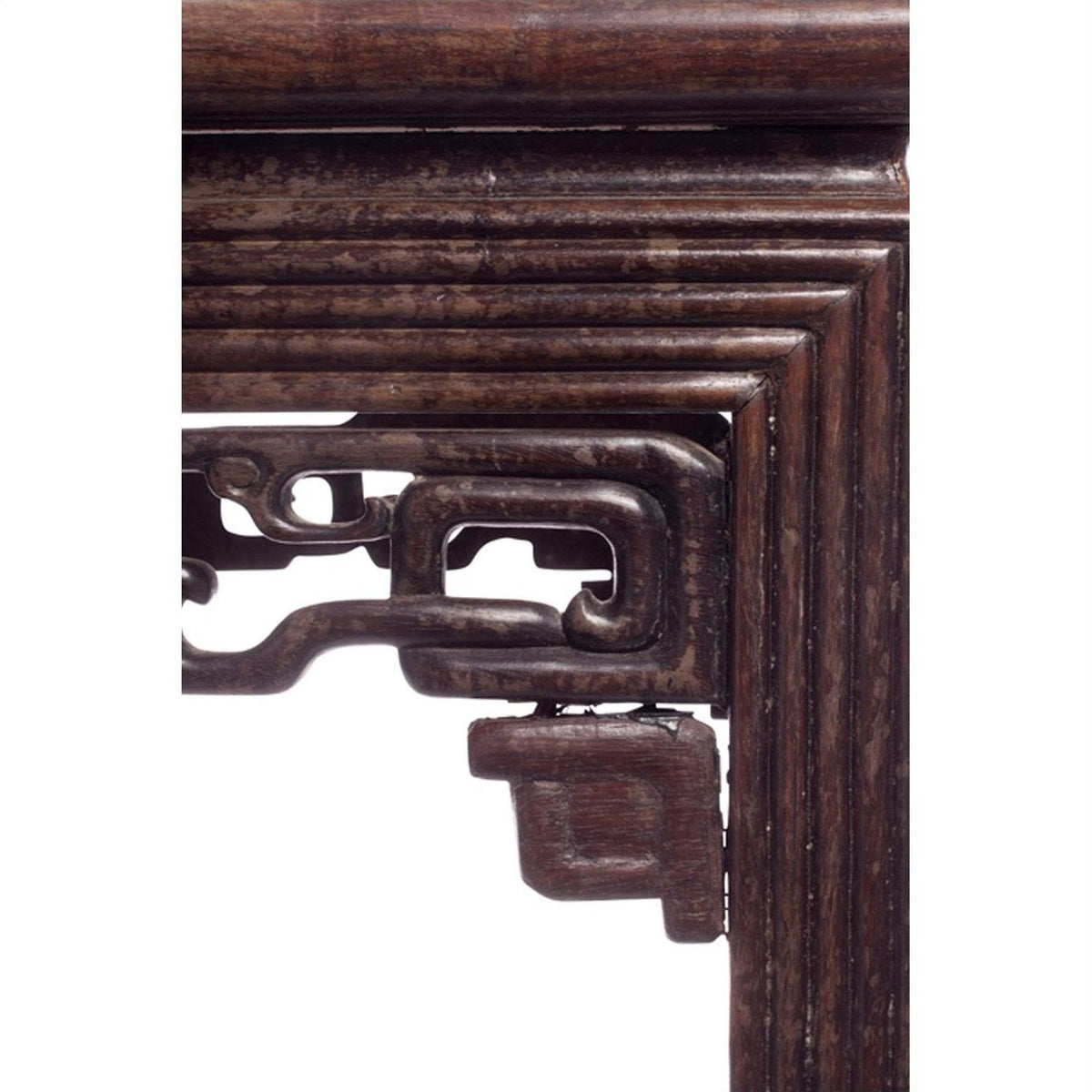 Close-up of dark wood carved and embellished side of antique Chinese side table.