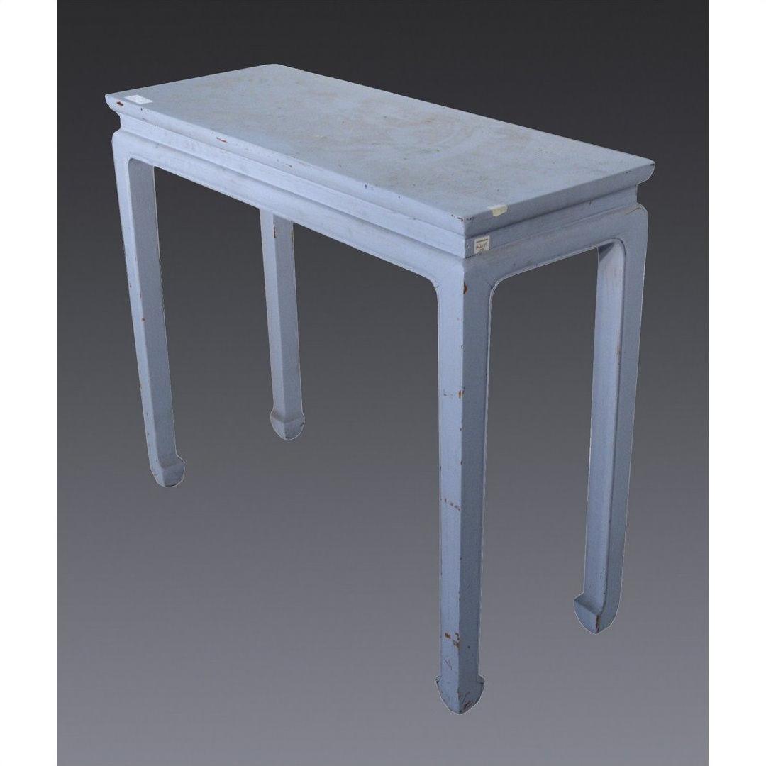 Close-up of vintage light blue wooden side table with four horse hoof feet and worn paint, against a gray background.