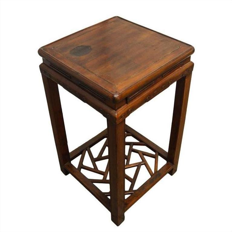 Brown wooden square side table with cracked ice textured base and geometric lower frame, close-up.