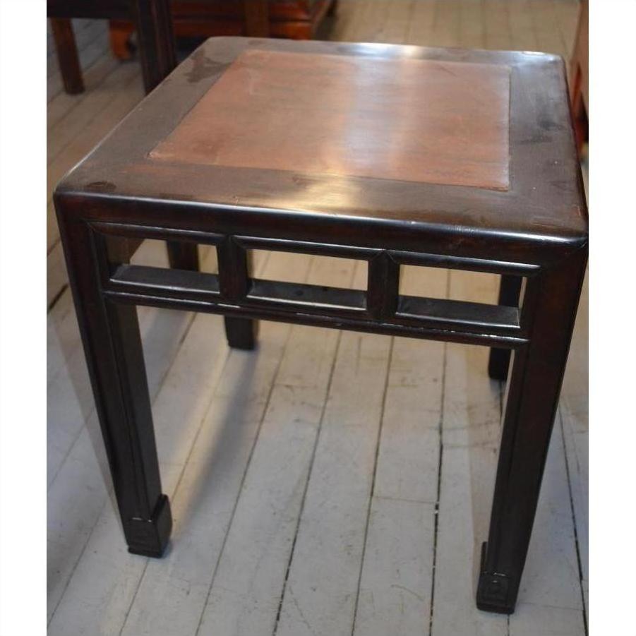 Brown burl wood side table with straight legs and flat top on a light wooden floor.
