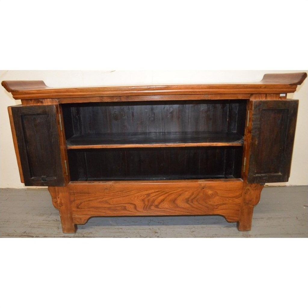 Wood sideboard with everted flanges, two open doors showing an interior shelf, visible natural wood grain.