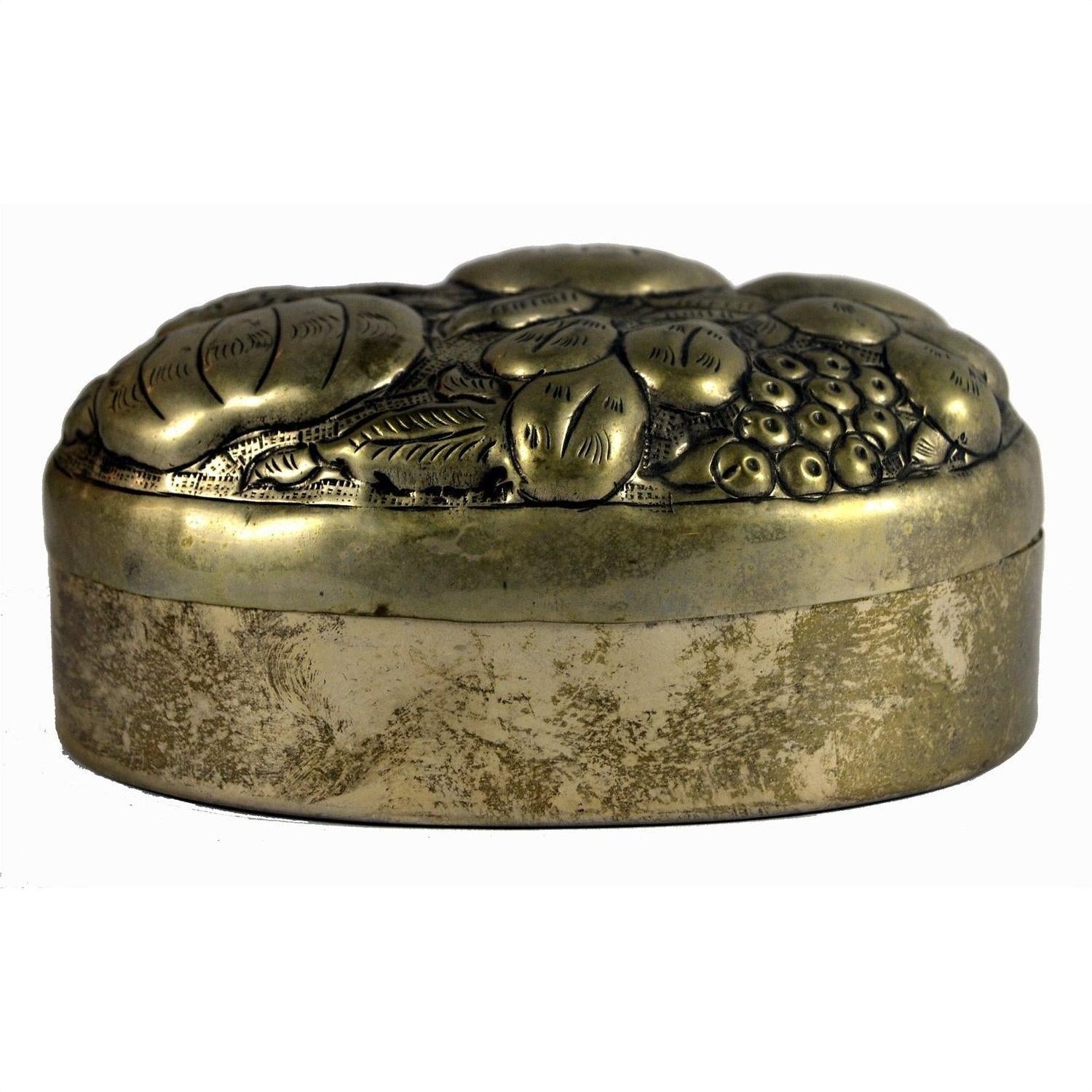 Silver plate oval jewelry box with ornate floral and fruit engravings on white background.