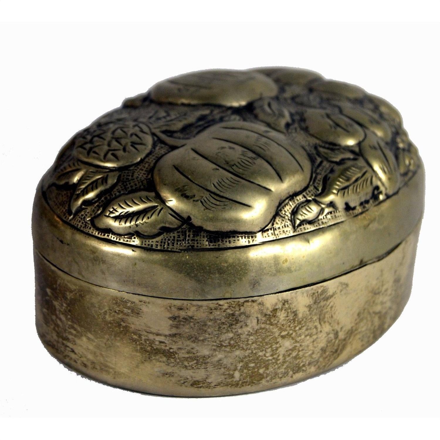 Close-up of silver plate jewelry box with ornate embossed floral and leaf design, oval shape, on lid.