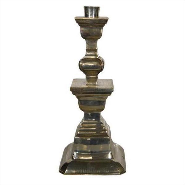 Silver plated candle holder with square base and ornate middle, Indian style, close-up.