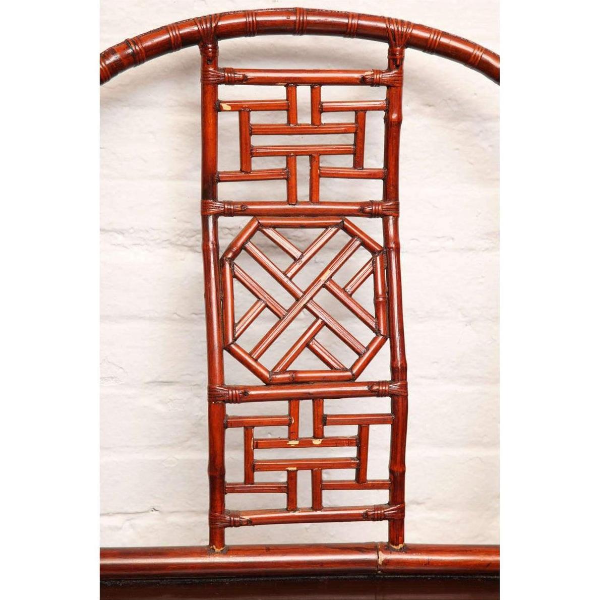 Close-up of brown bamboo and elm horseshoe-back armchair with geometric and circular patterns, 19th century Chinese style.
