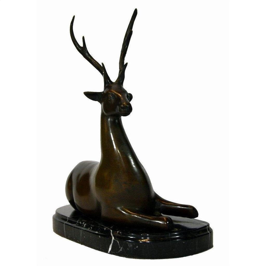 Bronze deer sculpture with antlers sitting on an oval marble base, close-up view.