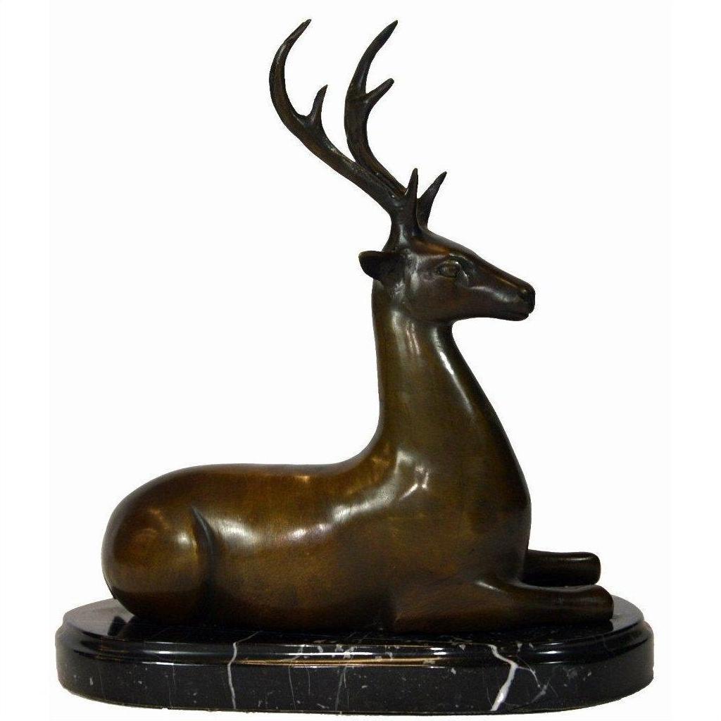 Bronze deer sculpture with antlers on black oval marble base, close-up view.