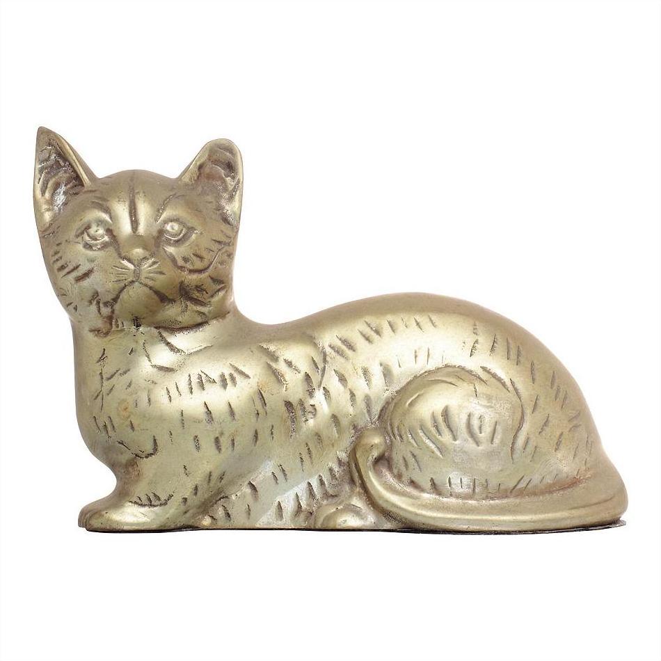 Silver plate cat figurine lying down with tail curled, close-up on white background.