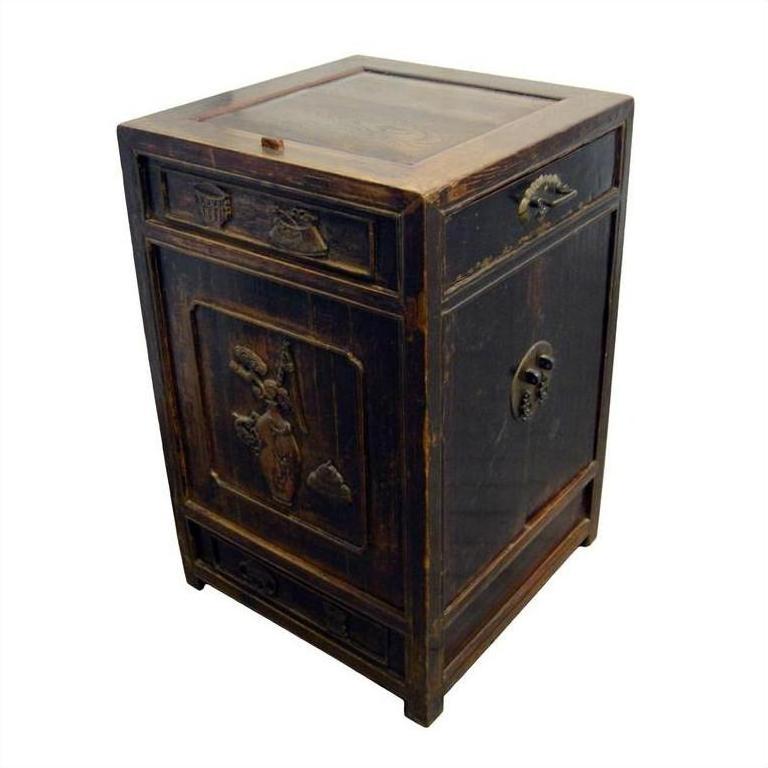 Dark wood antique side cabinet with metal handles, hand-carved details, and visible age and wear on the surface.