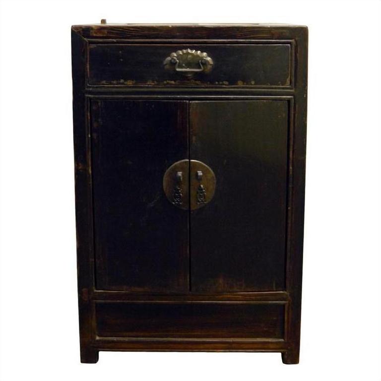 Dark wood carved side cabinet with one drawer, two doors, metal handles, and brass medallion lock plate.