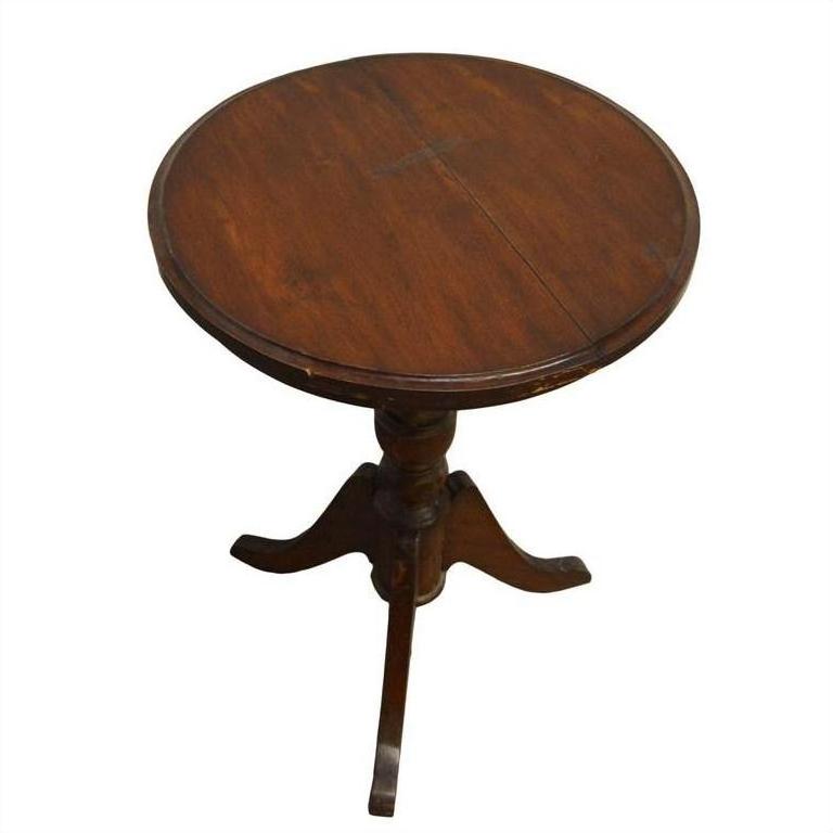 Wooden table with pedestal base and three curved legs, suitable for living room or common area use.