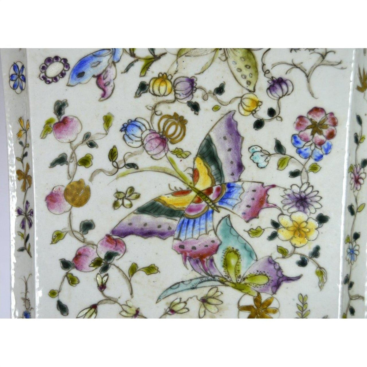 White porcelain vase with hand painted colorful butterflies and pink, yellow, blue flowers, tall design, close-up view.