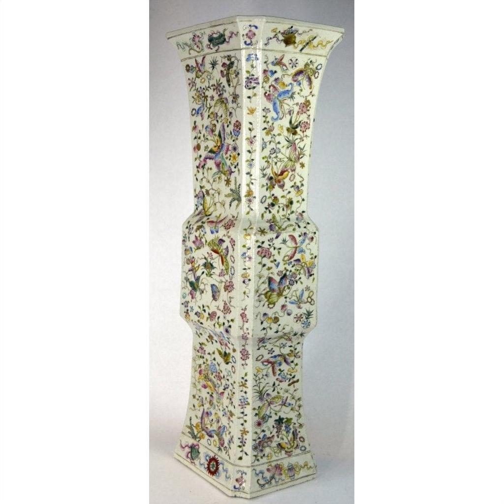 White porcelain vase with flared top, decorated with colorful flowers and butterflies, shown against plain background.