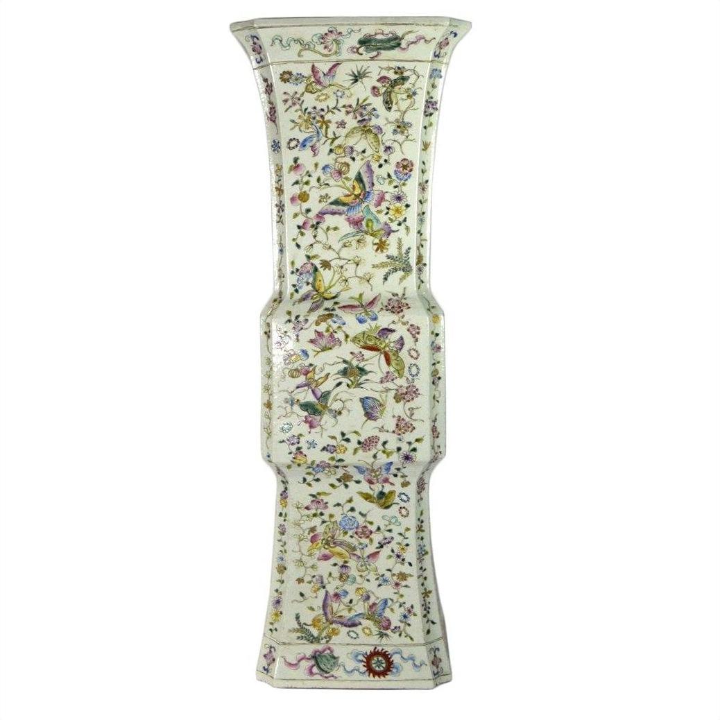 White porcelain tall Chinese vase with hand painted floral and butterfly design, flared top, close-up view.