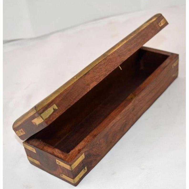 Brown teakwood pencil and jewelry box with open hinged lid on a white surface.