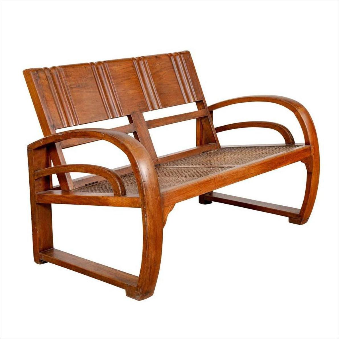 Brown teak wood settee with folding back, looping arms, and cane seat on a white background.