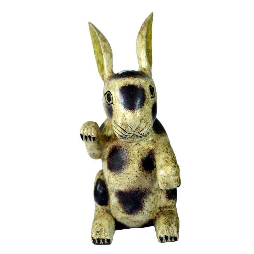 Close-up of vintage hand painted ceramic Thai Begging Rabbit figurine with tall ears, raised paw, and worn finish.
