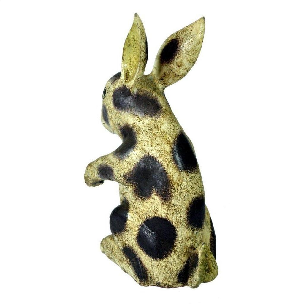 White ceramic Thai Begging Rabbit figurine with upright ears, hand painted, rear view on white background.