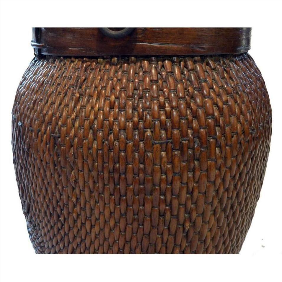 Close-up of brown wicker and wood basket with textured weave, showing side detail.