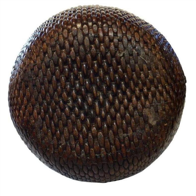 Close-up of a dark brown Thai basket with textured, scale-like surface.