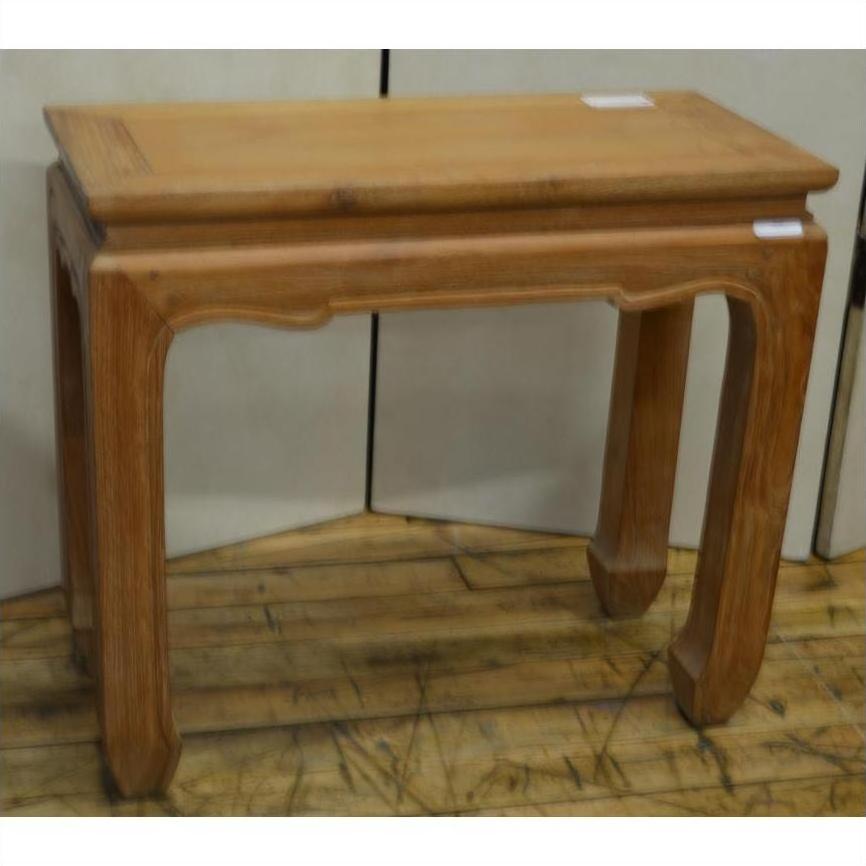 Brown teak wood rectangular table with vintage design and curved horse hoof feet, on wooden floor by white wall.