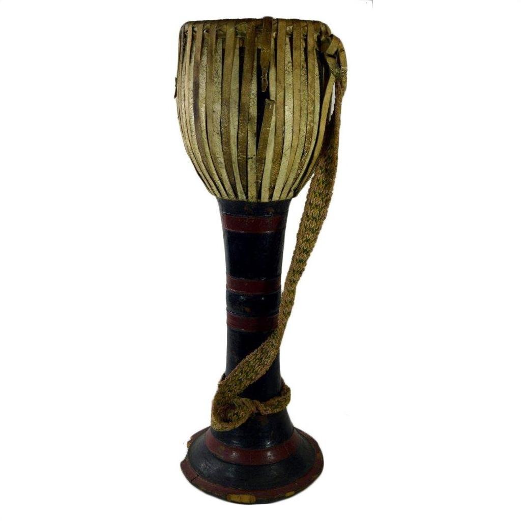 Brown wooden Thai tribal bongo drum with hourglass shape, vertical lacing, and woven strap, close-up view.