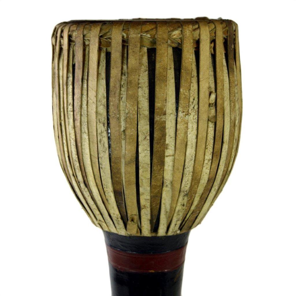 Close-up of a dark wood Thai tribal bongo drum with vertical natural fiber strips, in good condition.