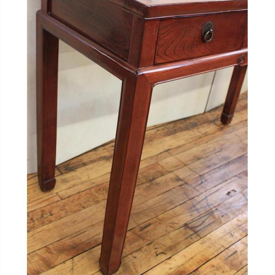 Light wood triple drawer desk with unique horse hoof feet on a pale wooden floor.