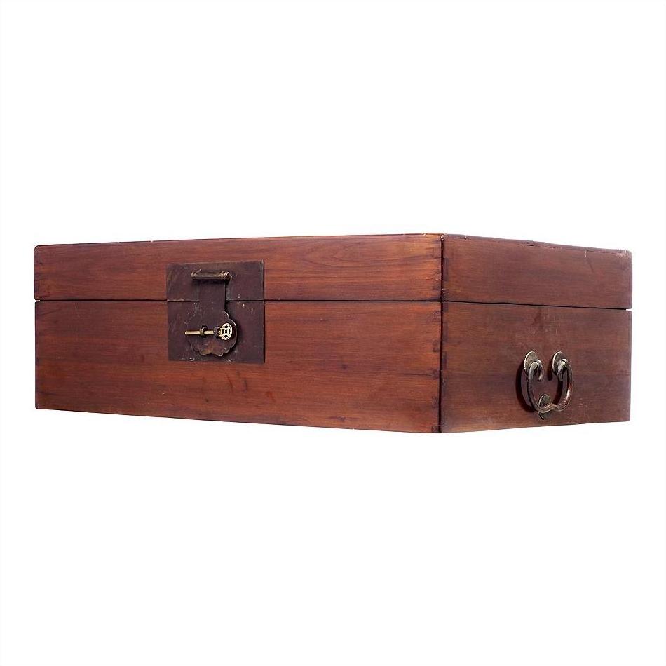Rectangular natural wood trunk with metal keyhole and side handles, shown on a white background.