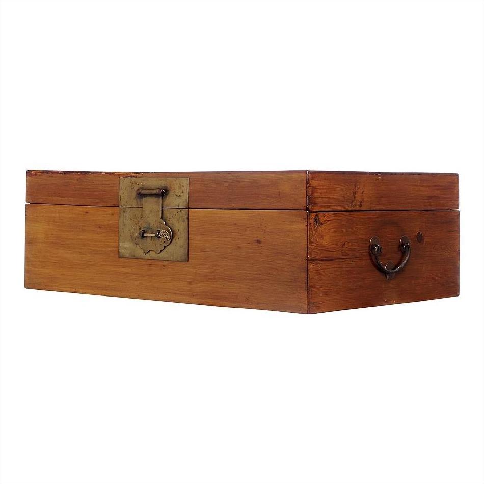 Brown wood rectangular trunk with brass hardware, metal latch, and handle on a plain white background.