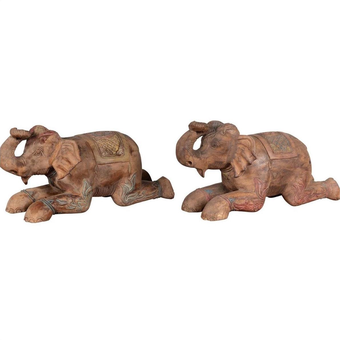 Close-up of two vintage Thai painted wood elephant sculptures with carved decorative patterns, from Chiang Mai.