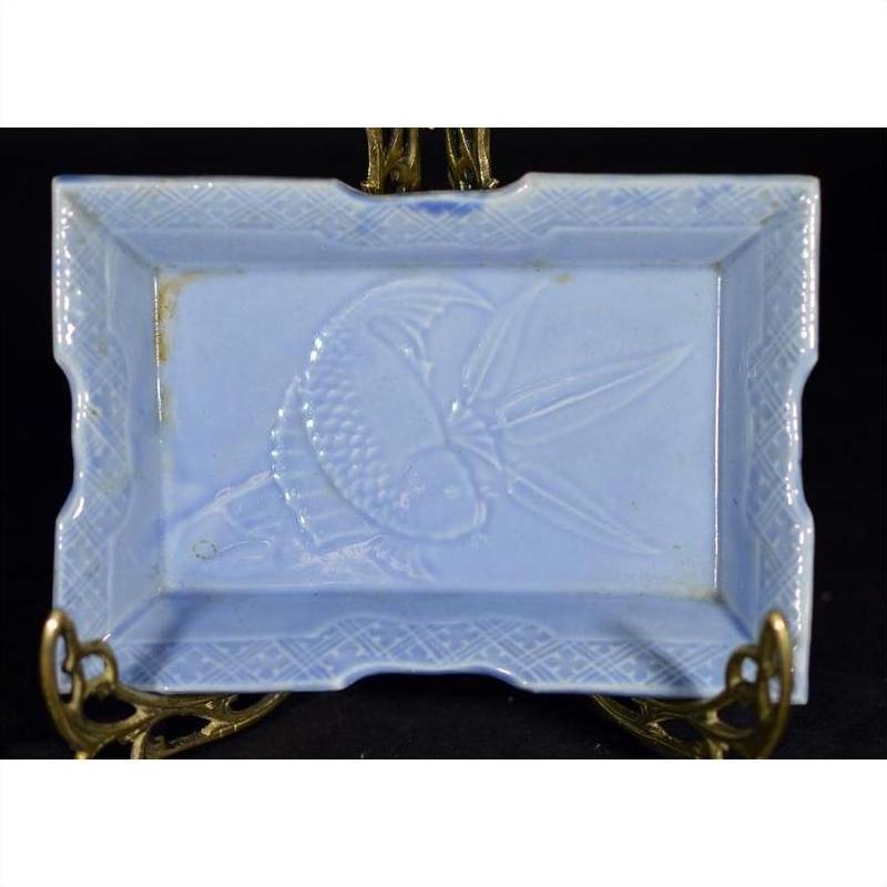 White porcelain dish with hand painted fish and seaweed design, vintage Asian style, on decorative brass stand.